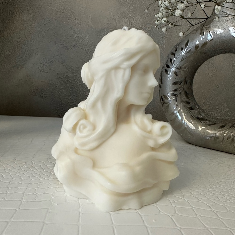 Large statue candle. Beautiful girl.